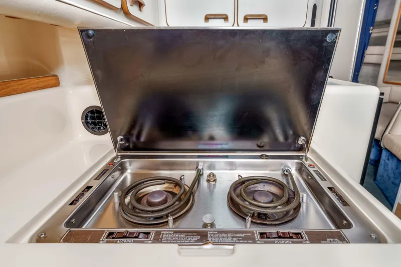 Sea Oddity Yacht Photos Pics 1991 Sea Ray 330 Sundancer boat kitchen with dual-burner stove.