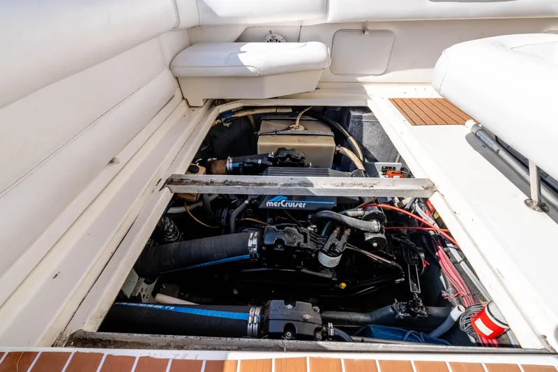 Sea Oddity Yacht Photos Pics 1991 Sea Ray 330 Sundancer engine compartment with MerCruiser engine visible.