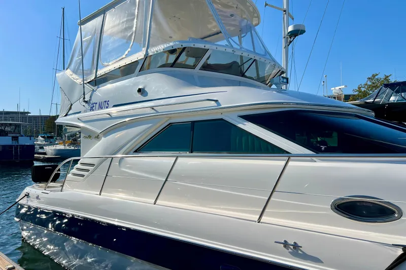 Get Nuts Yacht Photos Pics 2000 Sea Ray 400 Sedan Bridge yacht docked in a marina under clear blue skies.