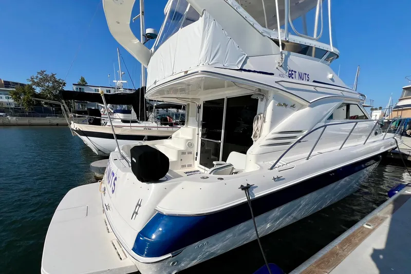 Get Nuts Yacht Photos Pics 2000 Sea Ray 400 Sedan Bridge yacht docked at marina, rear view.