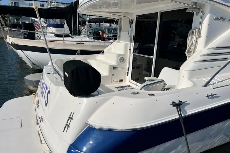 Get Nuts Yacht Photos Pics 2000 Sea Ray 400 Sedan Bridge yacht docked at marina, showcasing spacious deck area.
