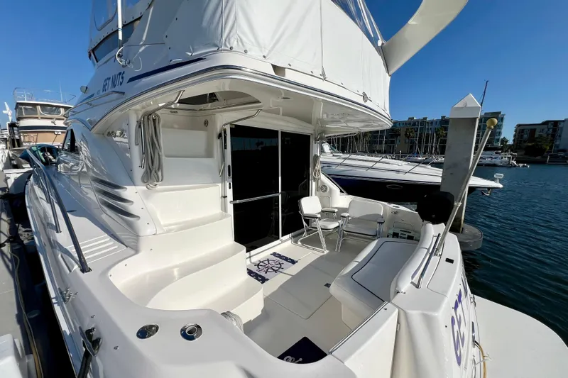 Get Nuts Yacht Photos Pics 2000 Sea Ray 400 Sedan Bridge yacht docked at marina, featuring spacious deck and seating.