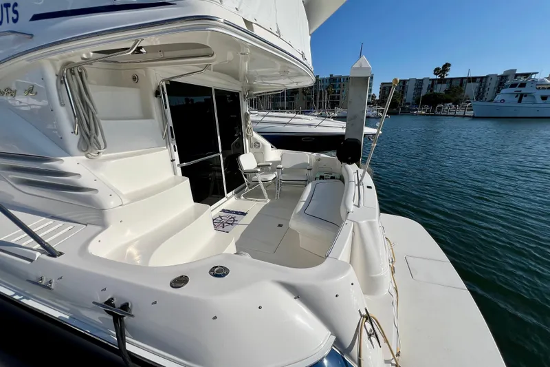 Get Nuts Yacht Photos Pics 2000 Sea Ray 400 Sedan Bridge yacht docked at marina, featuring spacious deck area.