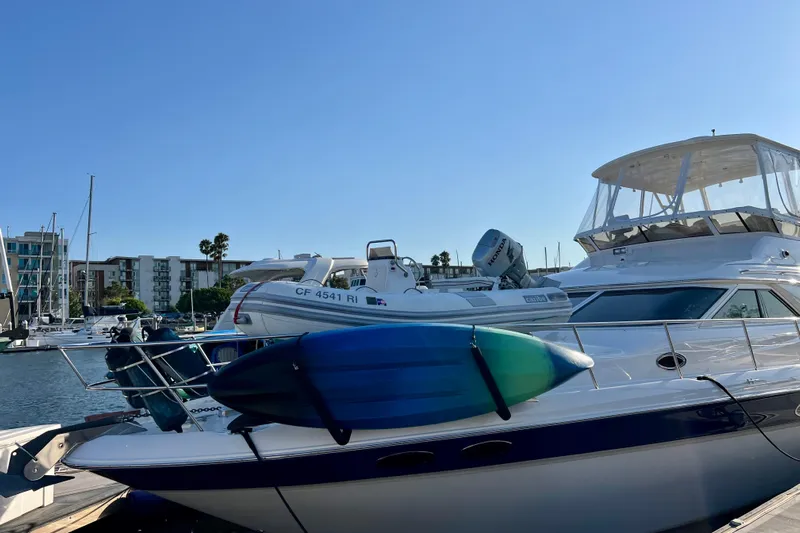 Get Nuts Yacht Photos Pics 2000 Sea Ray 400 Sedan Bridge yacht docked with kayak on deck.
