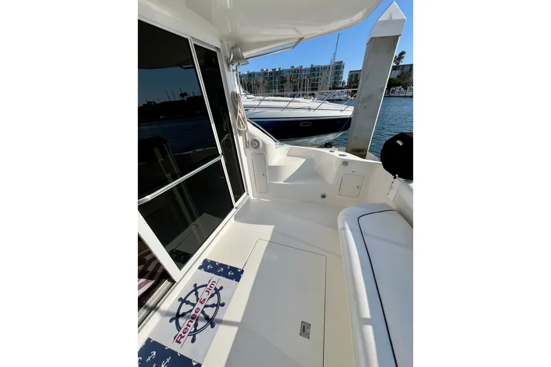 Get Nuts Yacht Photos Pics 2000 Sea Ray 400 Sedan Bridge yacht docked, featuring spacious deck and marina view.