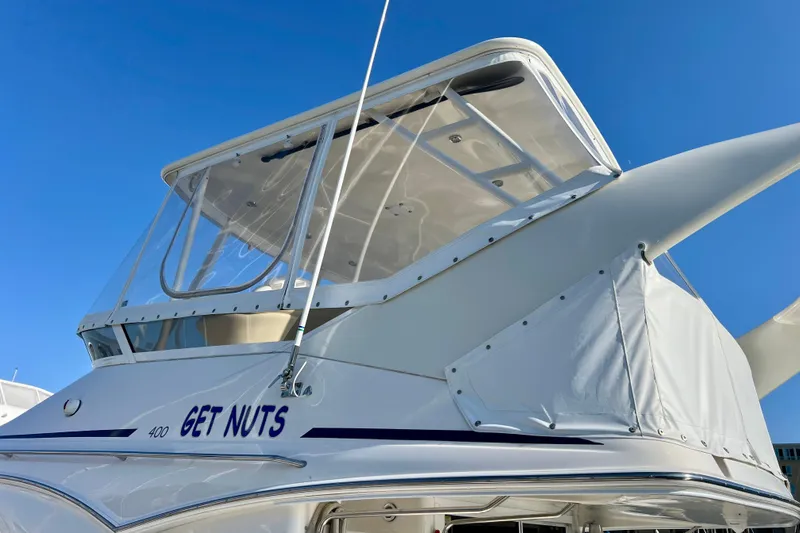 Get Nuts Yacht Photos Pics Sea Ray 400 Sedan Bridge 2000 yacht with custom name, clear skies background.