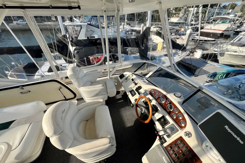 Get Nuts Yacht Photos Pics Interior view of a 2000 Sea Ray 400 Sedan Bridge yacht cockpit with luxurious seating.