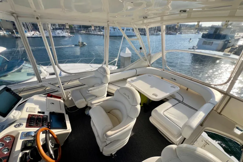 Get Nuts Yacht Photos Pics Luxurious interior of 2000 Sea Ray 400 Sedan Bridge yacht with marina view.
