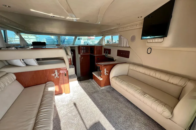 Get Nuts Yacht Photos Pics Luxurious interior of a 2000 Sea Ray 400 Sedan Bridge yacht with plush seating and modern amenities.
