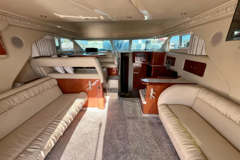 Get Nuts Yacht Photos Pics Interior of 2000 Sea Ray 400 Sedan Bridge yacht with beige seating and wood accents.