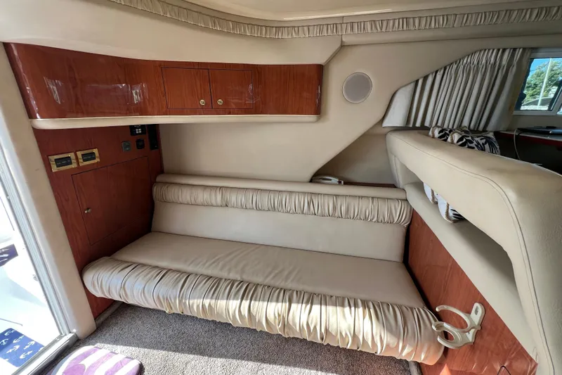 Get Nuts Yacht Photos Pics Interior of 2000 Sea Ray 400 Sedan Bridge with beige seating and wooden cabinets.
