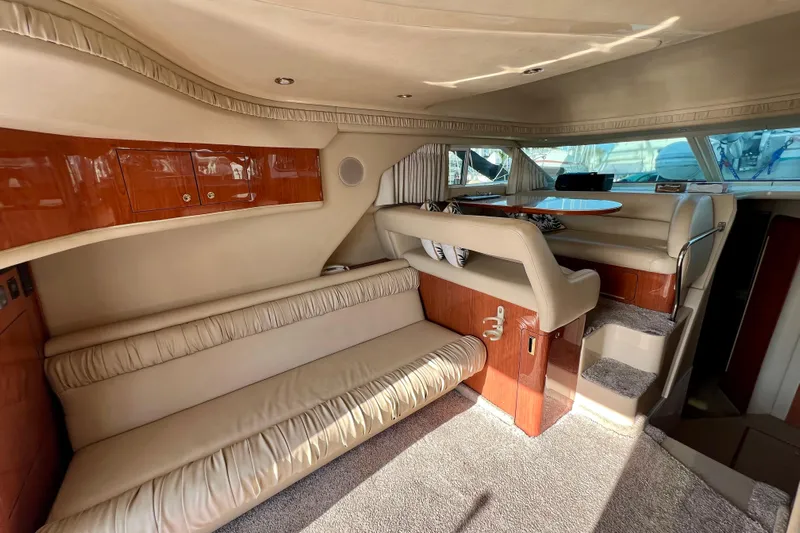 Get Nuts Yacht Photos Pics Luxurious interior of 2000 Sea Ray 400 Sedan Bridge yacht with plush seating and wood accents.