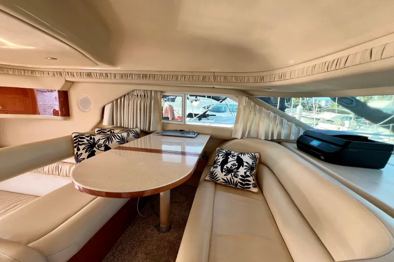 Get Nuts Yacht Photos Pics Interior of 2000 Sea Ray 400 Sedan Bridge with beige seating and decorative pillows.