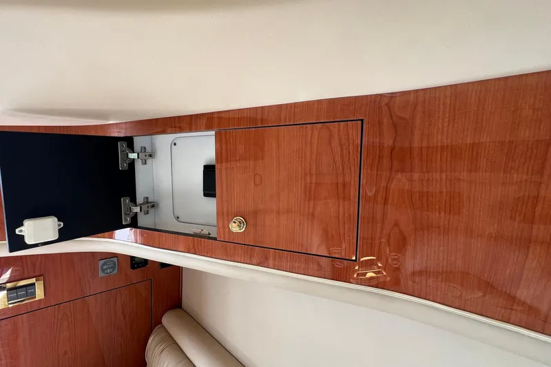 Get Nuts Yacht Photos Pics Interior of 2000 Sea Ray 400 Sedan Bridge with open wooden cabinet.