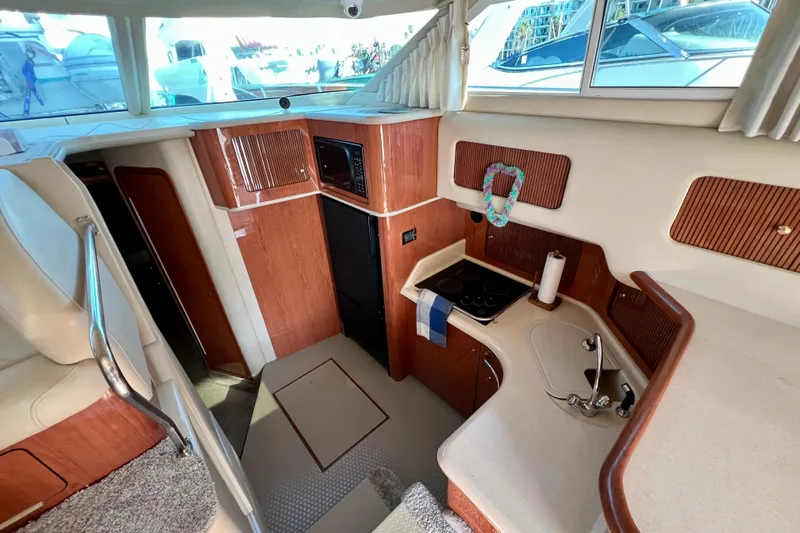 Get Nuts Yacht Photos Pics Interior of 2000 Sea Ray 400 Sedan Bridge yacht, featuring a compact kitchen area.