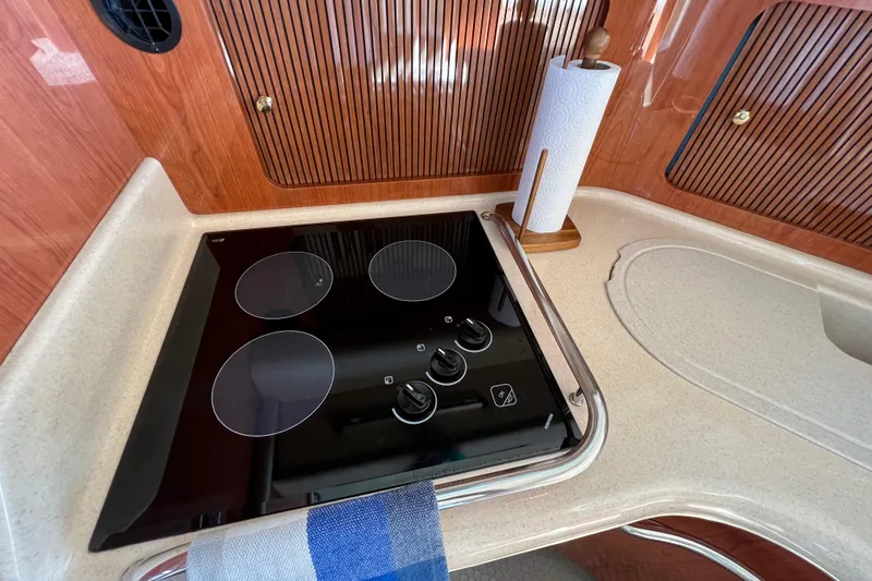 Get Nuts Yacht Photos Pics Modern kitchen in 2000 Sea Ray 400 Sedan Bridge yacht with stovetop and paper towel holder.
