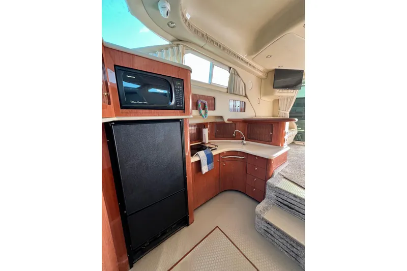 Get Nuts Yacht Photos Pics Interior of 2000 Sea Ray 400 Sedan Bridge with kitchen amenities and modern design.