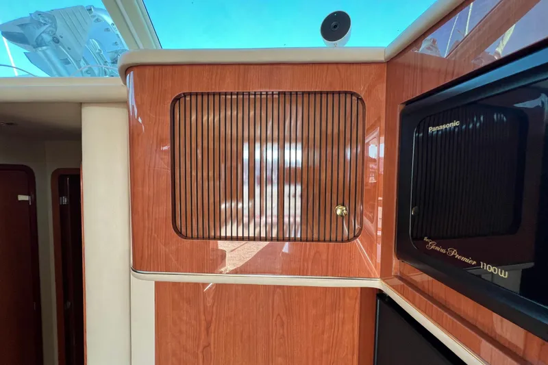 Get Nuts Yacht Photos Pics Interior of 2000 Sea Ray 400 Sedan Bridge with wood cabinetry and Panasonic microwave.