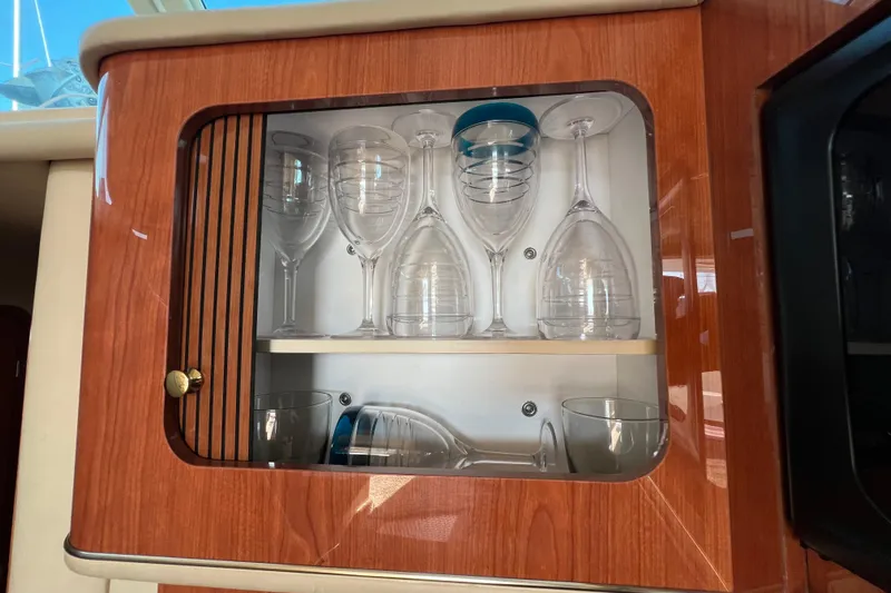 Get Nuts Yacht Photos Pics Glass cabinet in 2000 Sea Ray 400 Sedan Bridge yacht interior.