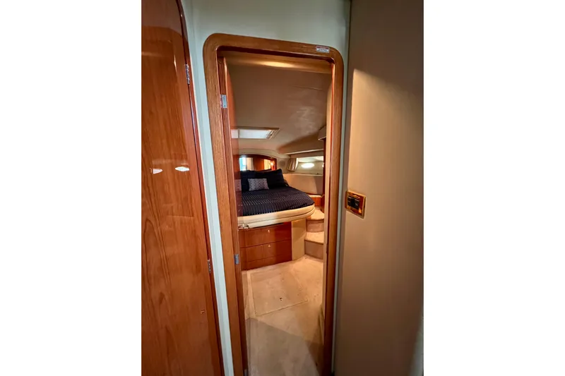 Get Nuts Yacht Photos Pics Interior cabin view of 2000 Sea Ray 400 Sedan Bridge yacht, featuring a cozy bedroom.