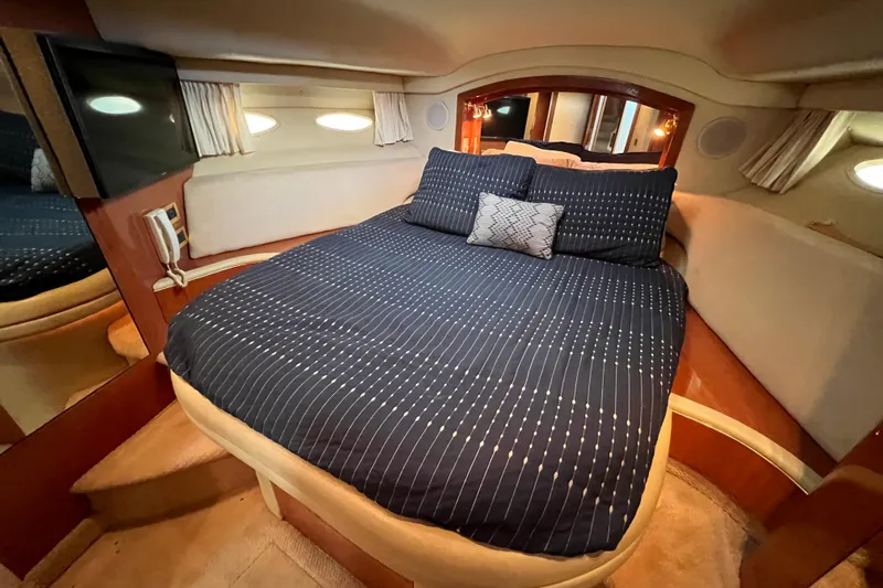 Get Nuts Yacht Photos Pics Luxurious bedroom interior of 2000 Sea Ray 400 Sedan Bridge yacht with cozy bedding.