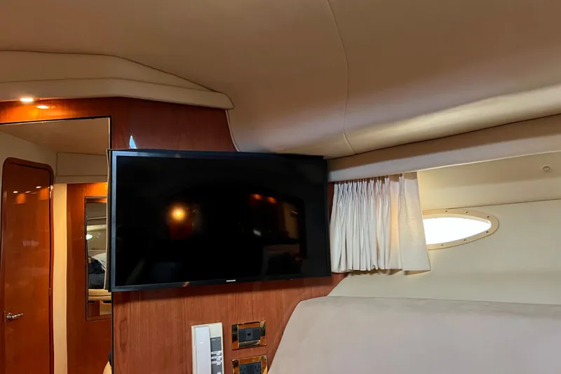 Get Nuts Yacht Photos Pics Interior of 2000 Sea Ray 400 Sedan Bridge with TV and wood paneling.