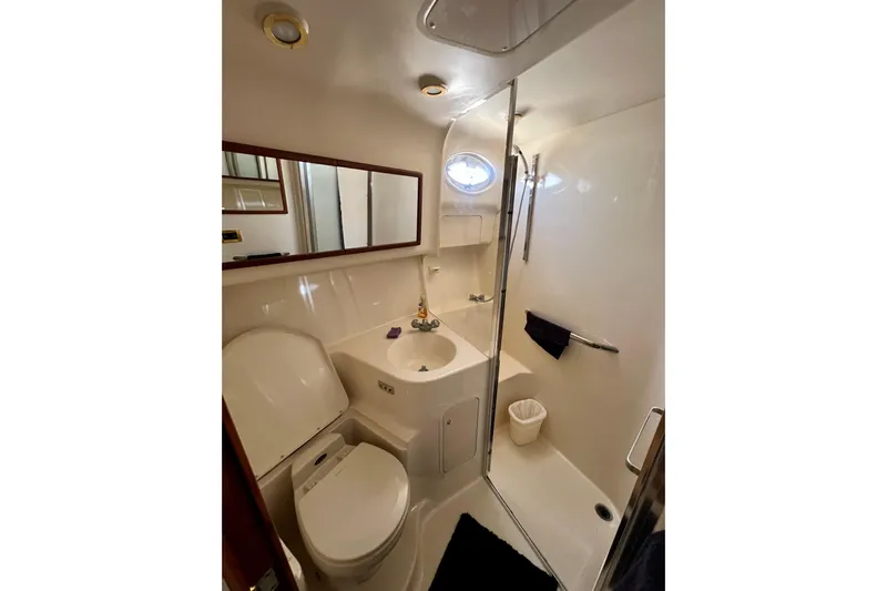 Get Nuts Yacht Photos Pics Bathroom interior of 2000 Sea Ray 400 Sedan Bridge yacht, featuring shower and toilet.
