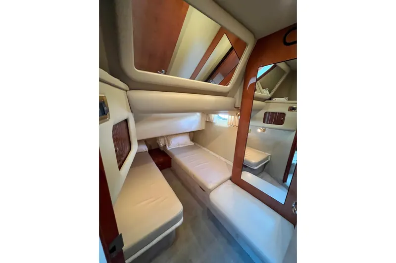 Get Nuts Yacht Photos Pics 2000 Sea Ray 400 Sedan Bridge cabin interior with cozy beds and wooden accents.
