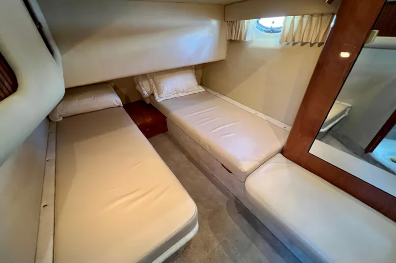 Get Nuts Yacht Photos Pics Interior cabin of 2000 Sea Ray 400 Sedan Bridge with twin beds and porthole.