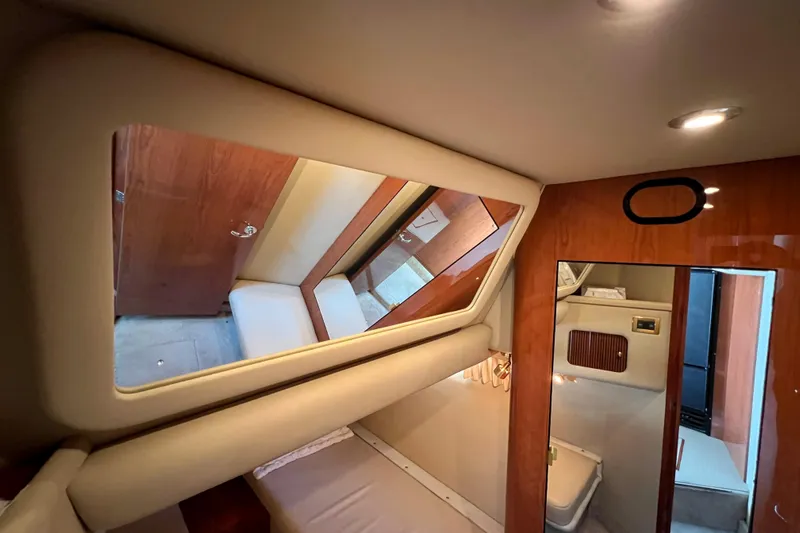 Get Nuts Yacht Photos Pics Interior cabin of 2000 Sea Ray 400 Sedan Bridge yacht, featuring wood accents and mirror.