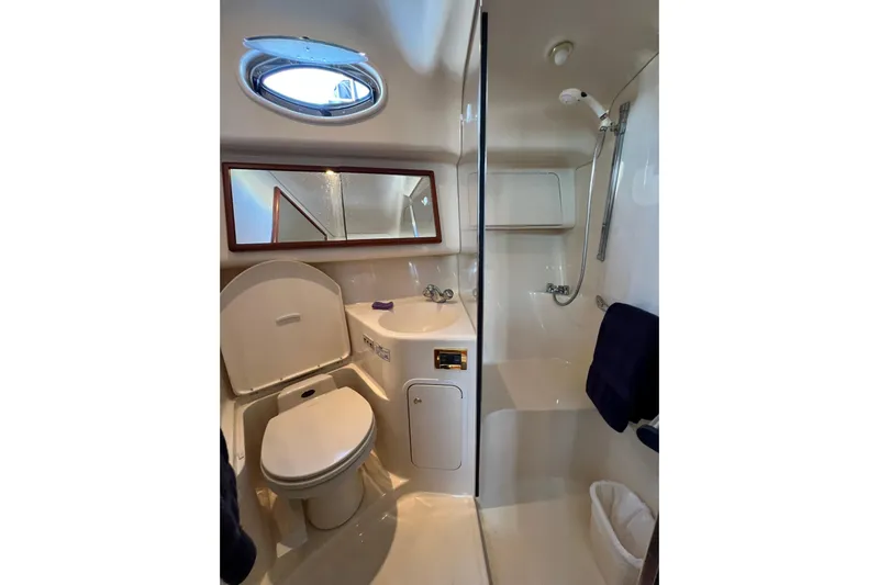 Get Nuts Yacht Photos Pics Bathroom interior of 2000 Sea Ray 400 Sedan Bridge yacht, featuring shower and toilet.