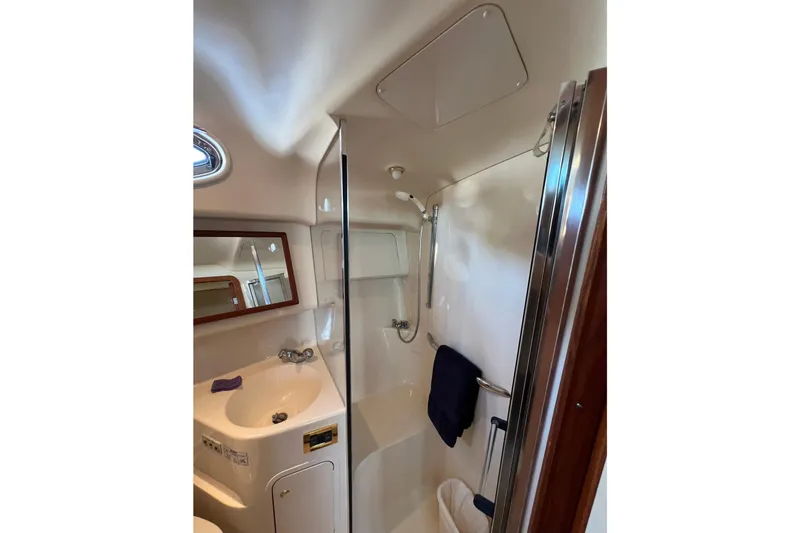 Get Nuts Yacht Photos Pics Bathroom interior of 2000 Sea Ray 400 Sedan Bridge yacht, featuring shower and sink.
