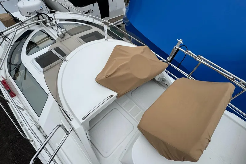 Tug Life Yacht Photos Pics 2017 Ranger Tugs R-29 CB boat deck with covered seating and railing.