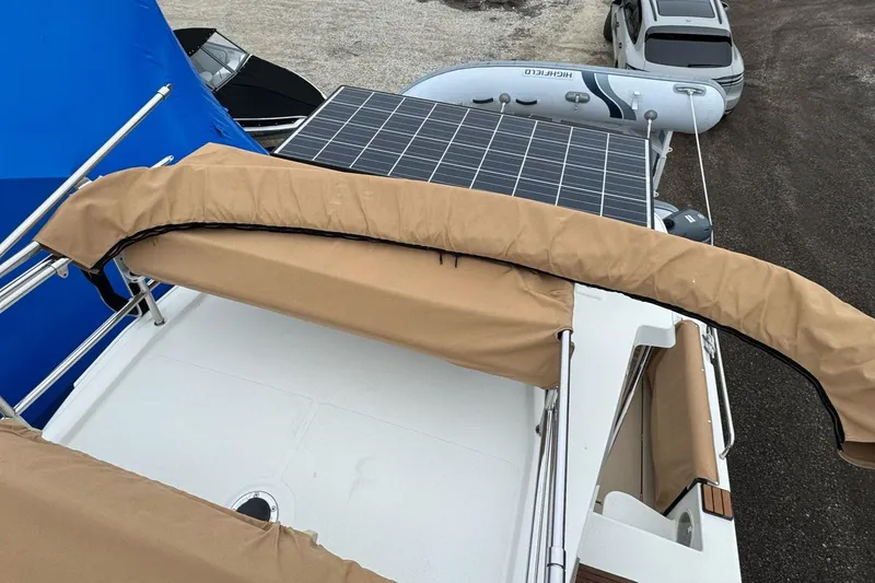 Tug Life Yacht Photos Pics 2017 Ranger Tugs R-29 CB boat with solar panels and beige canopy.