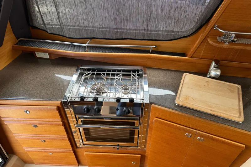 Tug Life Yacht Photos Pics 2017 Ranger Tugs R-29 CB galley with stove, countertop, and cutting board.