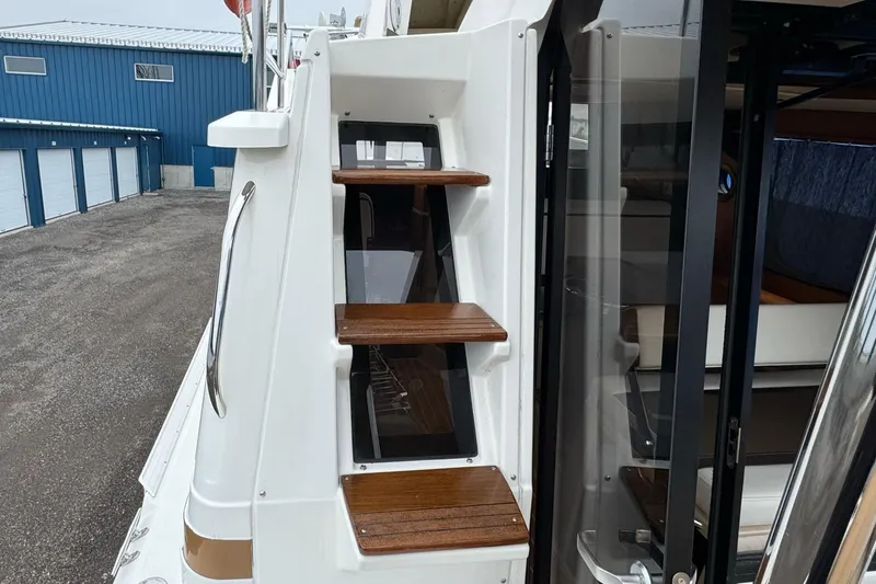 Tug Life Yacht Photos Pics 2017 Ranger Tugs R-29 CB boat with wooden steps and sleek exterior design.