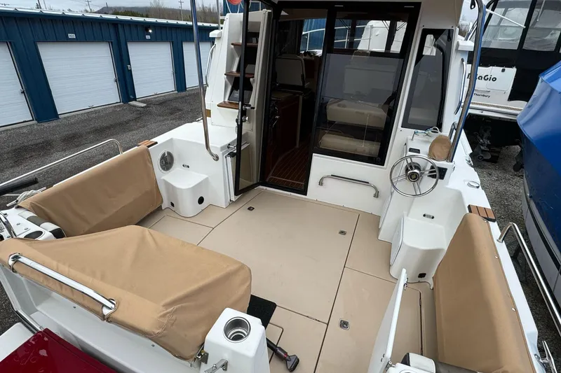Tug Life Yacht Photos Pics 2017 Ranger Tugs R-29 CB boat deck with beige seating and storage compartments.
