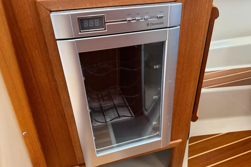 Tug Life Yacht Photos Pics Dometic wine cooler in 2017 Ranger Tugs R-29 CB, wooden cabinetry, digital display.