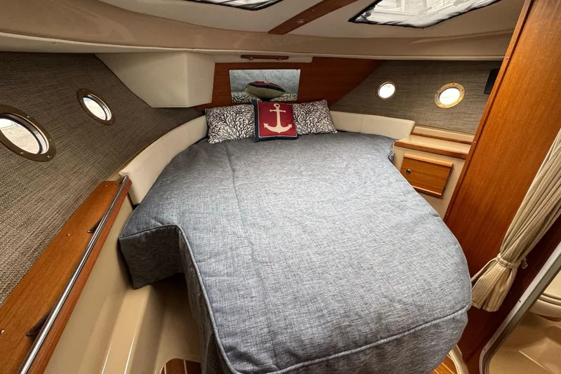 Tug Life Yacht Photos Pics 2017 Ranger Tugs R-29 CB cabin with cozy bed and nautical decor.
