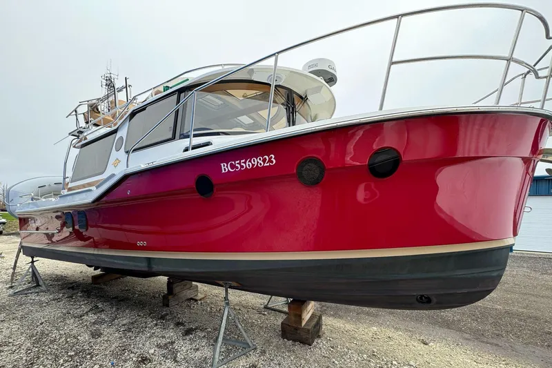 Tug Life Yacht Photos Pics 2017 Ranger Tugs R-29 CB boat with red hull on dry dock.