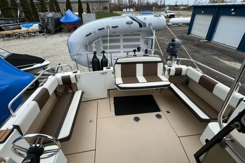 Tug Life Yacht Photos Pics 2017 Ranger Tugs R-29 CB boat deck with seating and inflatable dinghy.