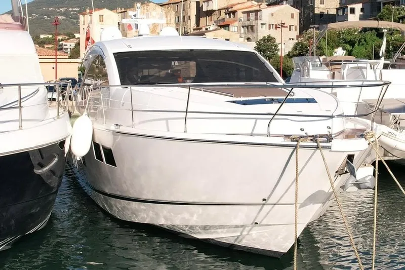  Yacht Photos Pics 2013 Fairline Targa 62 GT yacht docked in a marina, surrounded by other boats.