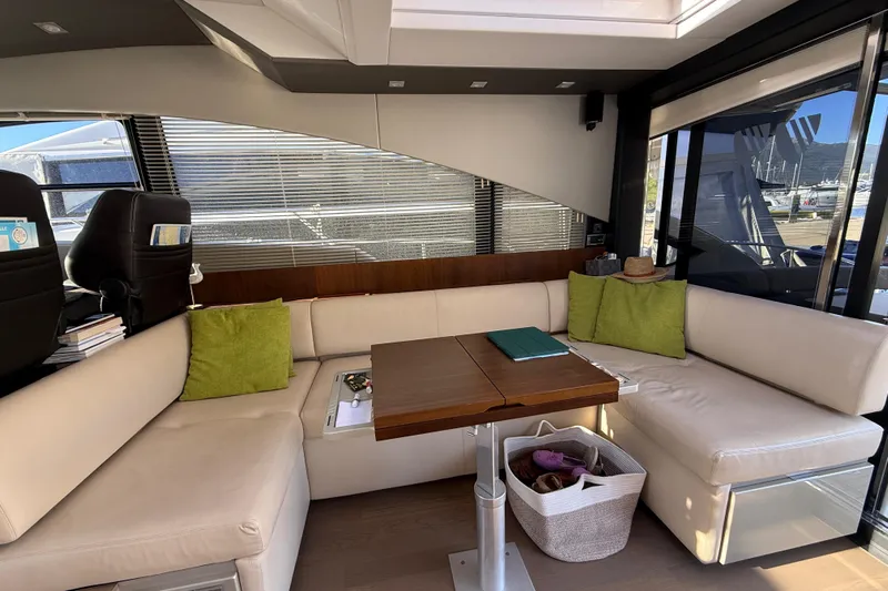  Yacht Photos Pics Luxurious interior of 2013 Fairline Targa 62 GT yacht with beige seating and wooden table.