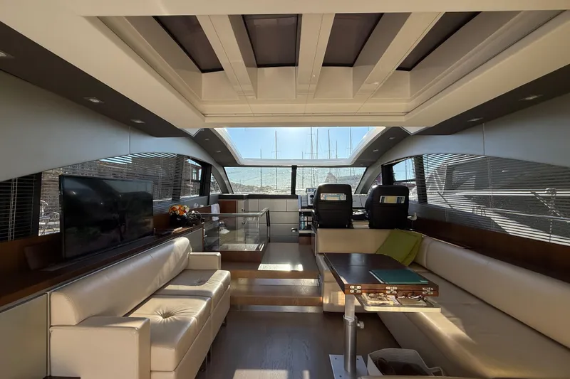  Yacht Photos Pics Luxurious interior of 2013 Fairline Targa 62 GT yacht with modern seating and panoramic windows.