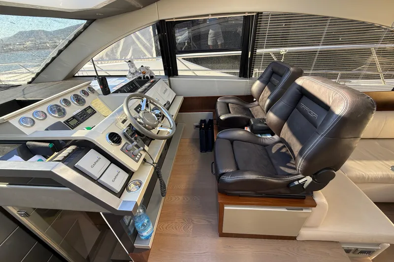  Yacht Photos Pics Luxurious helm of 2013 Fairline Targa 62 GT yacht with leather seats and modern controls.