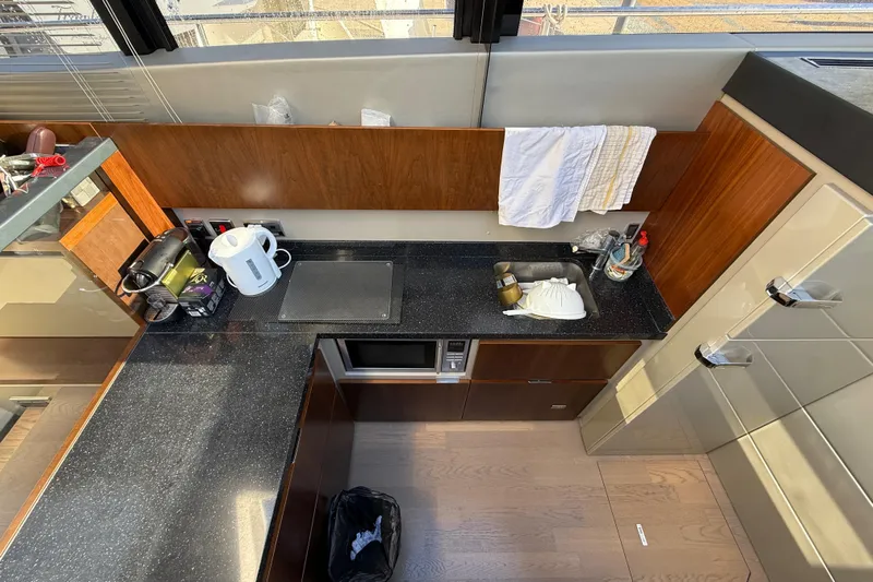  Yacht Photos Pics Modern kitchen interior on 2013 Fairline Targa 62 GT yacht, featuring sleek countertops and appliances.