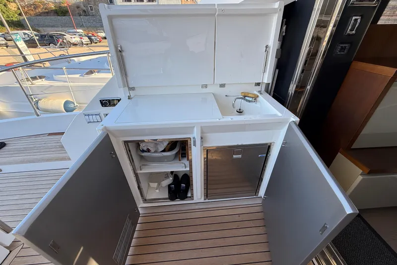  Yacht Photos Pics Outdoor kitchenette on 2013 Fairline Targa 62 GT yacht with sink and storage.