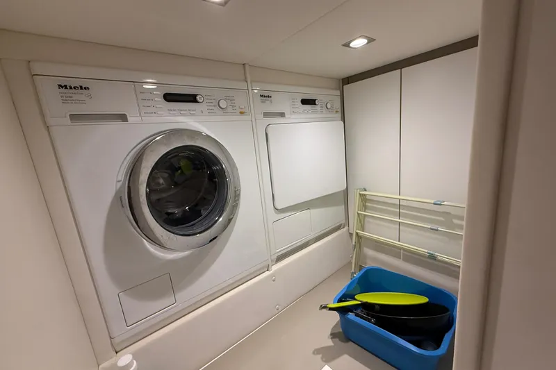 Yacht Photos Pics Laundry area on 2013 Fairline Targa 62 GT yacht with Miele appliances and drying rack.