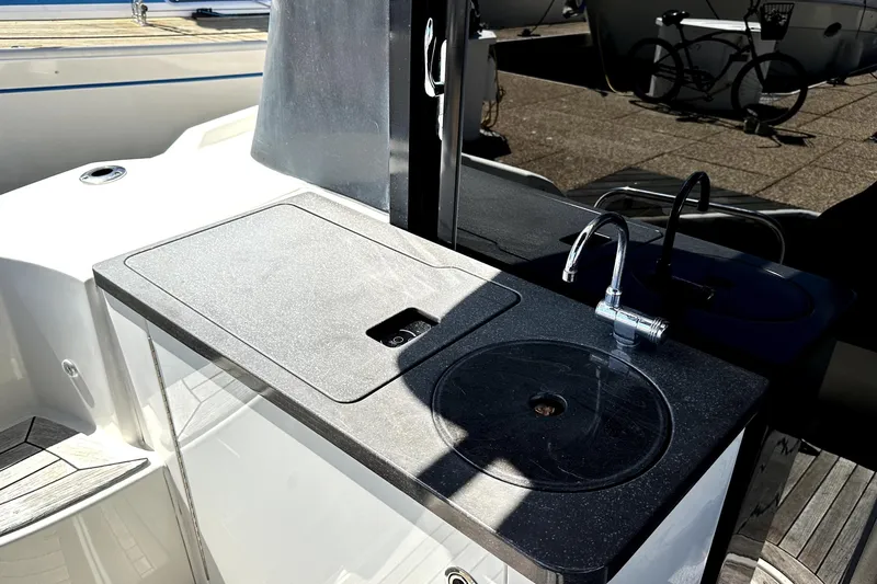 Baby Pie Yacht Photos Pics Outdoor kitchenette on 2016 Sea Ray 470 Sundancer yacht, featuring sink and countertop.