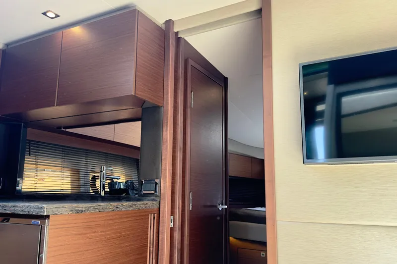 Baby Pie Yacht Photos Pics Interior of 2016 Sea Ray 470 Sundancer yacht with modern kitchen and TV.